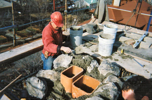 stones being reset in new mortar